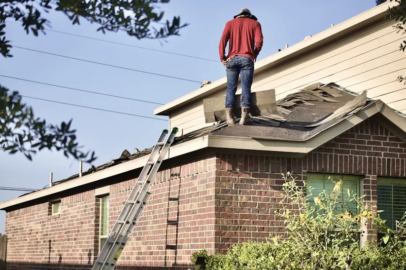 Professional roofer working on a residential roof in Lamanda Park